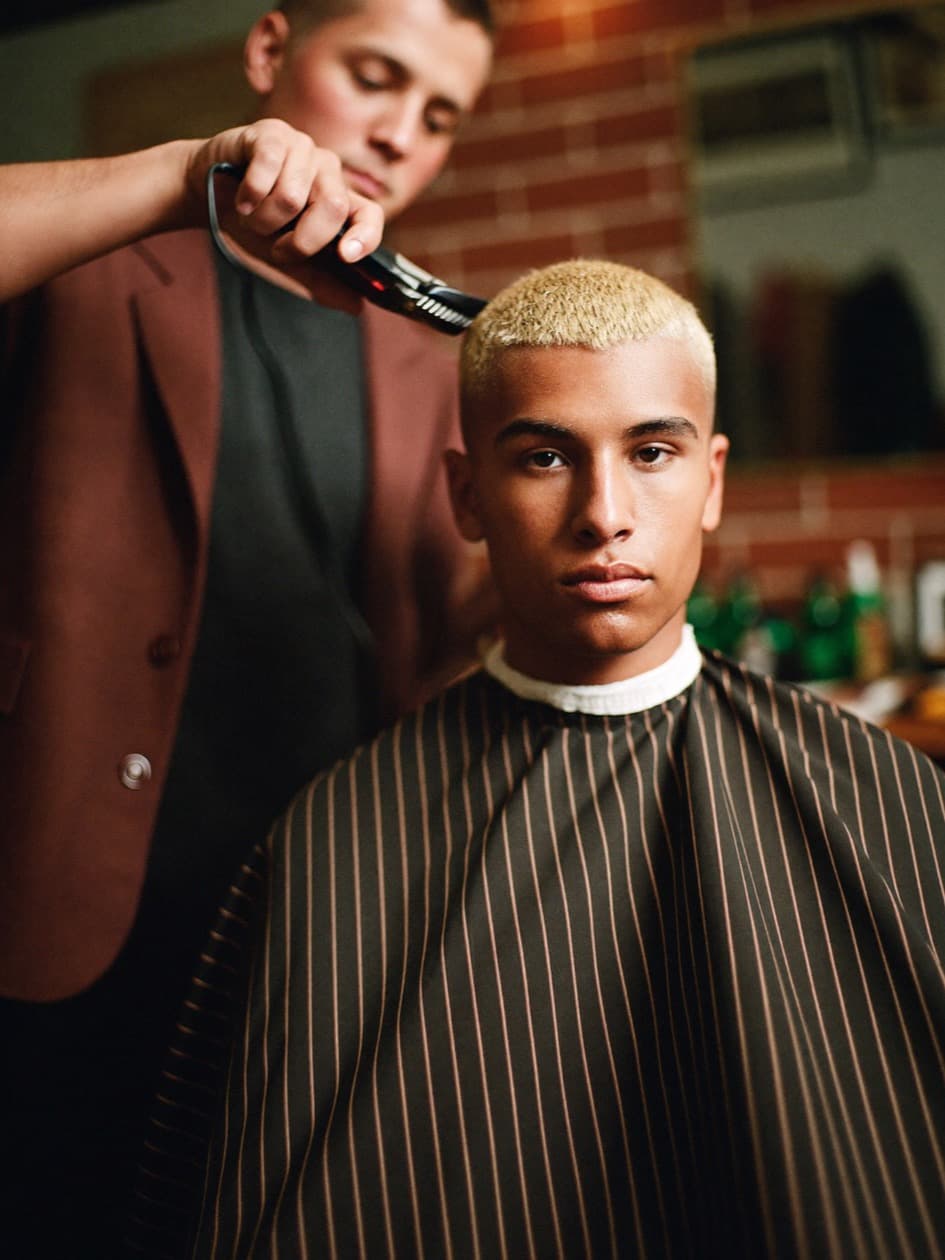 A barber finishing a cut
